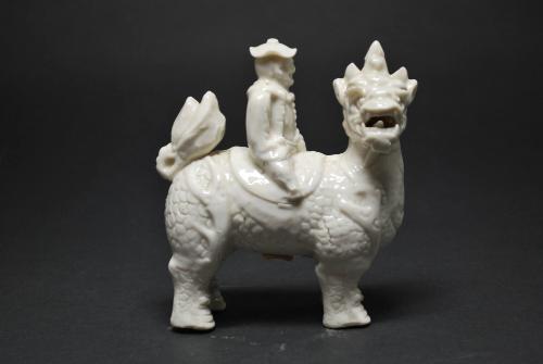Man riding an animal (qilin)