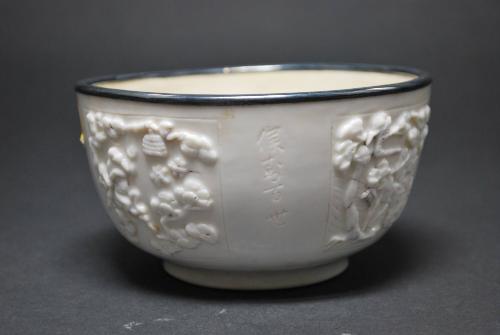 Bowl with metal rim and molded panels