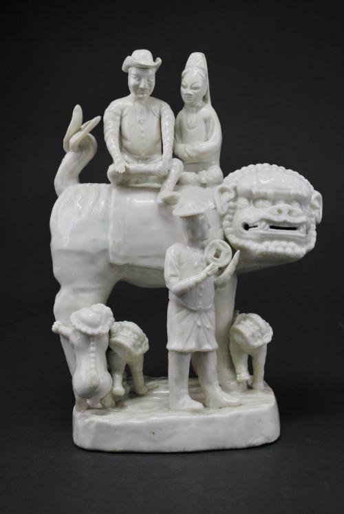 European family riding on a Buddhist lion