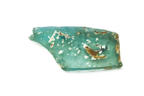 Aqua blue three-inch piece of glass with white and brown areas