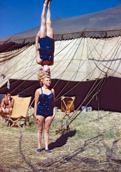 Lucia and Gerda Muller of the Chaludis in Costume, balancing on their heads