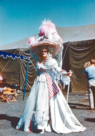 Woman in long white dress & large hat
