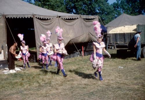 Ladies in pink, white & blue costumes