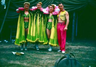 Alzana Troupe in yellow, green, and red garb