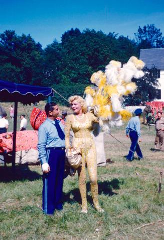 Man in blue uniform with lady in yellow costume