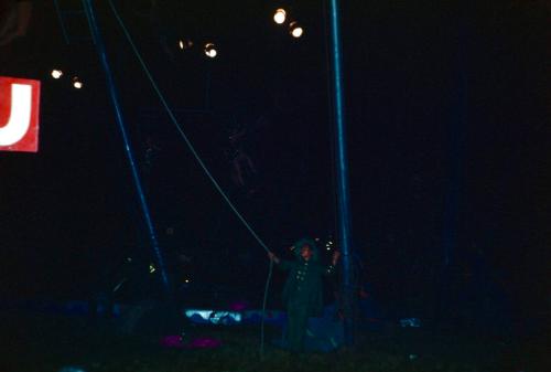 Performer in green garb under the BT