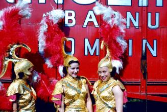 3 ladies in gold costumes