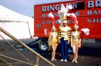 2 ladies and 1 man in gold costumes