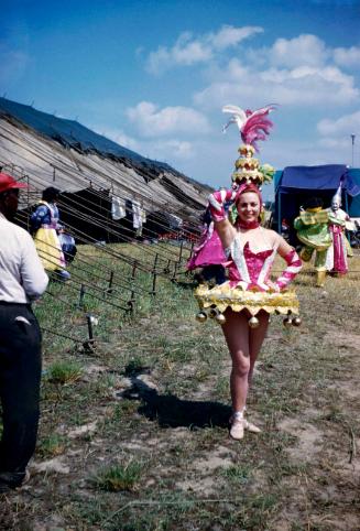 Lady in pink, white, and gold costume