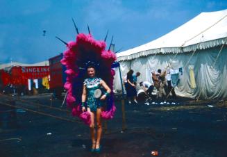 Lady in blue garb and elaborate purple/pink headdress