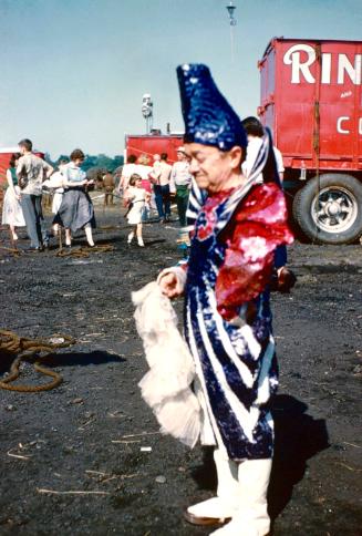 Paul Horompo in white/blue/red clown costume in BY