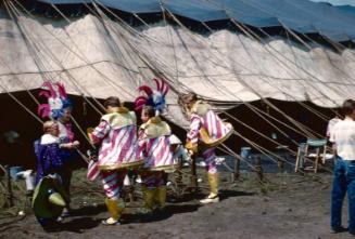 3 performers in pink/white/gold costumes