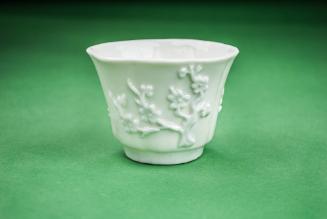 Cup with decorated fluted sides